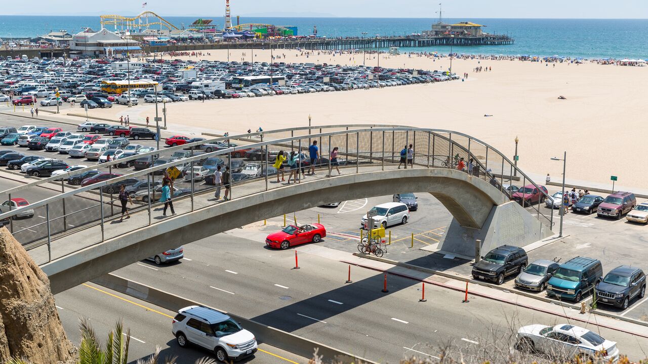 People Walking Over the Arizona Pedestrian Overpass With the Beach in the Background